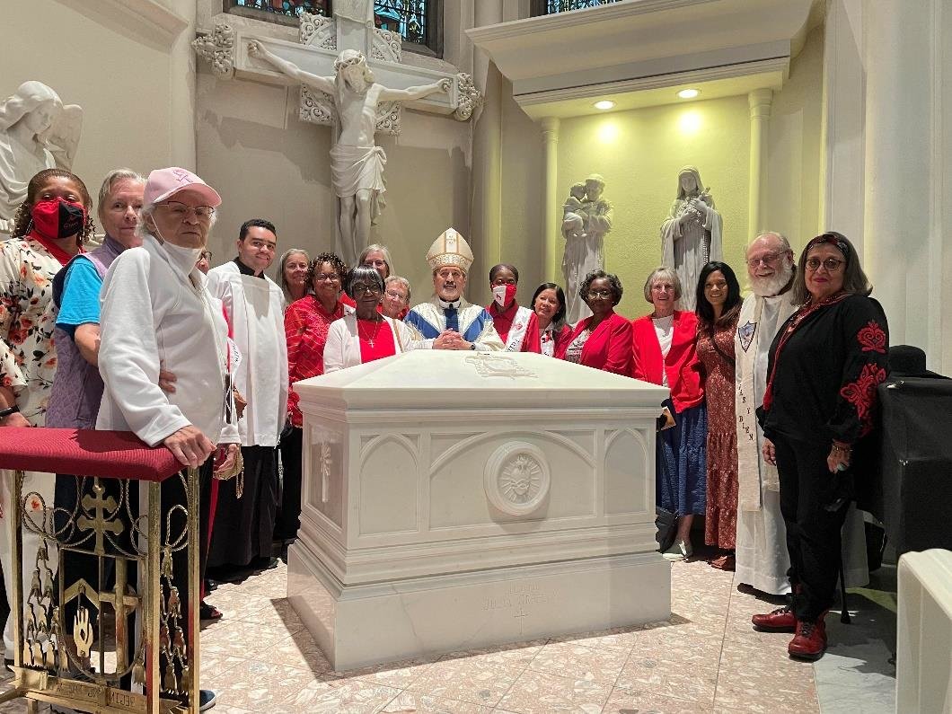 Members of the Julia Greeley Guild gather at the resting place of Servant of God Julia Greeley in the Cathedral Basilica of the Immaculate Conception in Denver after Mass on June 6, the day before the 104th anniversary of “Beloved Julia Greeley’s” death.